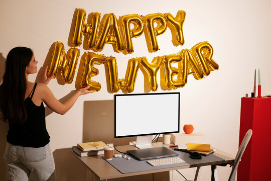 Desktop mockup with white screen and happy new year balloons