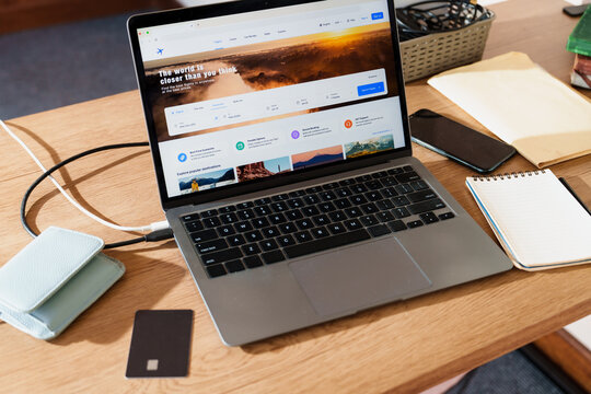 Laptop with Flight Booking Website on Desk with Credit Card