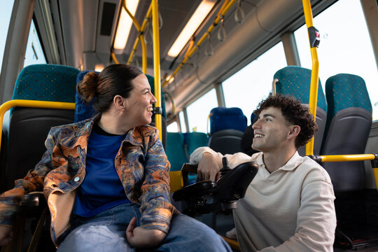 People talking and smiling on accessible public transport