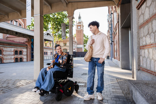 Diverse friends laughing walking together in urban setting