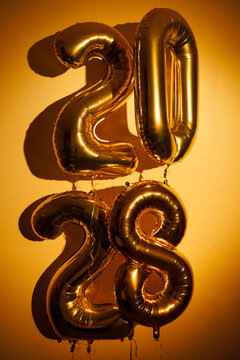 Gold foil balloons forming 2028 new year numbers