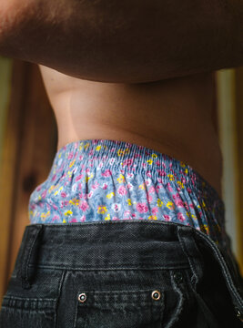 The Man Is Dressed In Bright Flower Underwear At Home