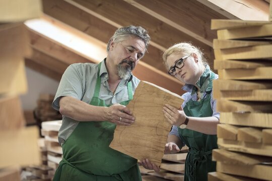 Employee and master violin maker Rainer W. Leonhardt choose wood in the warehouse, Mittenwald, Bavaria, Germany