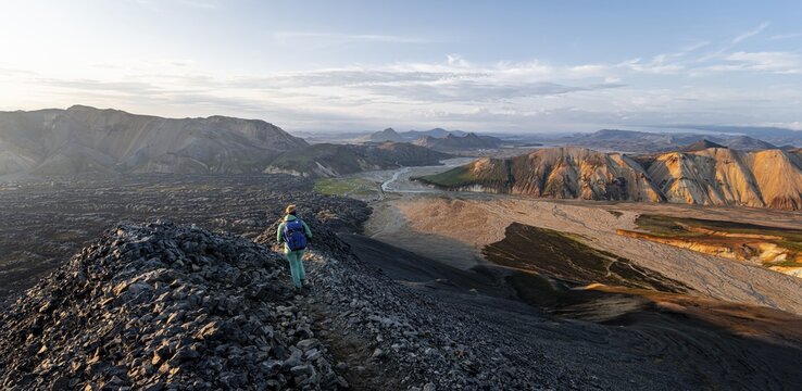 Hiker on the Laugavegur trekking trail, Laugavegur trekking trail, Dramatic volcanic landscape, Colourful erosion landscape with mountains, Lava field, Landmannalaugar, Fjallabak nature reserve, Su&eth;urland, Iceland