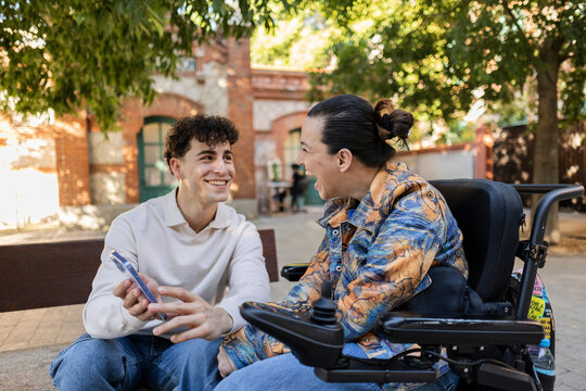 Diverse friends laughing and sharing a moment outdoors