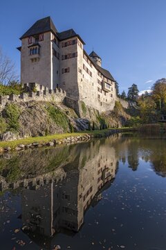 Matzen Castle and the castle pond in autumn, Brixlegg, Tyrol, Austria