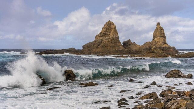 The north-west coast of La Gomera. The rock formation Baja de Los Roques, also known as Roques de Arguamul. Sea, waves, sun and clouds. Guillama, La Gomera, Canary Islands, Spain