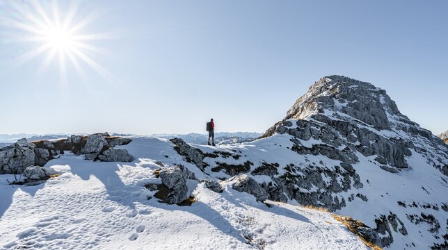 Climbers on the rocky summit ridge with first snow in autumn, hiking trail to Guffert, solar reflex, Brandenberg Alps, Tyrol, Austria