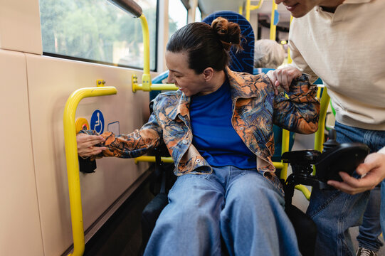 Person in wheelchair using public transportation with assistance