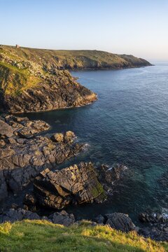 Coastal landscape at Botallack Mine, also known as Crown Mine. The ruins of Wheal Edward in the background. Evening, golden hour. Botallack, Penzance, Cornwall, England, Great Britain