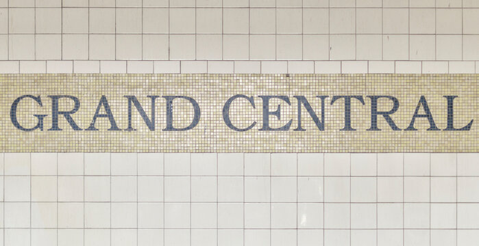 grand central sign on white pole in new york city subway station at 42nd street in midtown (4,5,6,7 and shuttle train) commuter stop travel tourism manhattan nyc usa america