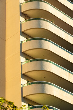 Curved balcony stack with sunlit residential repetition