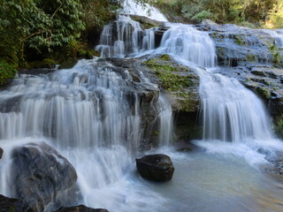 Naklejka premium Cascading Piedras Blancas Waterfall Over Mossy Rocks in the Rainforest of Misiones, Argentina
