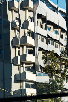 Reflected apartment facade warped in mirrored glass