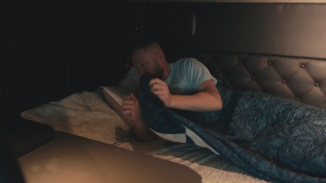 Truck driver falling asleep in the sleeper cab of his truck