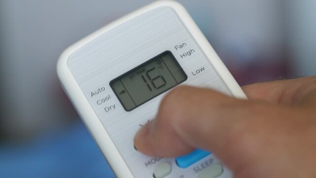 Turning Down Temperature on Thermostat in Summer in Hot Weather. Setting Digital Home Thermostat to Cool and Programming Air Conditioner. Adjusting Room Temperature to Energy Saving in Summer Heat.