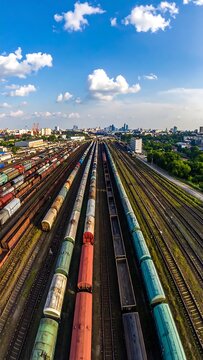 Colorful Freight Trains Lined on Parallel Railway Tracks in Expansive Urban Rail Yard
