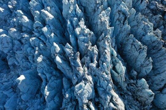 Aerial view of the rugged ice formations and deep crevasses of Falljokull glacier in Svinafell, Sveitarfelagid Hornaf, Iceland.