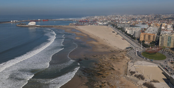 Aerial view of Castelo do Queijo and the sandy coastline with Atlantic ocean waves, urban buildings, and a coastal road in Porto, Porto, Portugal.