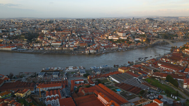 Aerial view of Cais de Gaia along the Douro River with the historic city of Porto and the Dom Luis I Bridge in the background, Vila Nova de Gaia, Porto, Portugal.