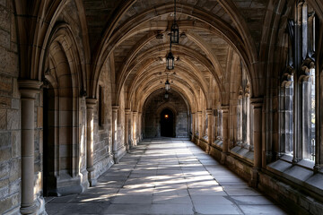 Obraz premium Gothic Stone Cathedral Corridor with Pointed Arches and Hanging Lanterns