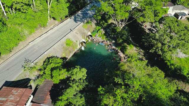 Aerial perspective of a public swimming pool known as La Alcantarilla surrounded by the dense vegetation of the high jungle in Tingo Maria, Peru.