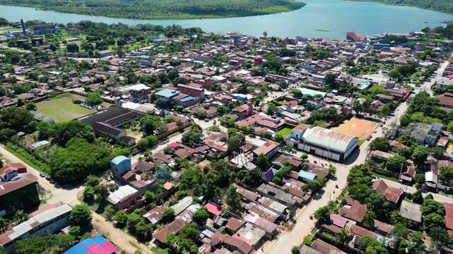 Drone point of view video gliding above Yarinacocha town toward the endless green jungle and the breathtaking Ucayali River horizon.