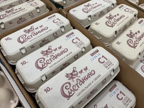 Khimki, Russia - June 25, 2026: Egg cartons featuring branding are neatly arranged in cardboard boxes, showcasing natural and fresh packaging design