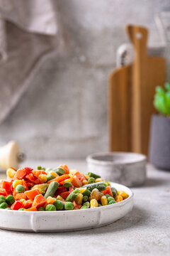 Frozen mix of vegetables on dark background
