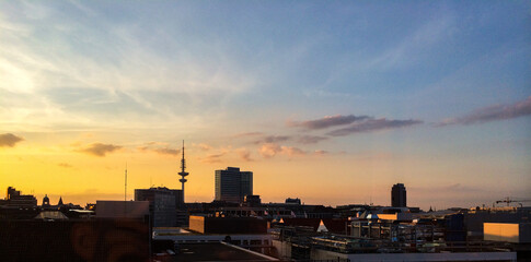 Hamburg skyline at sunset with Fernsehturm TV tower silhouette and golden sky © Michael Persson