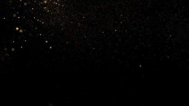 Golden waves motion abstract of particles gold dust with stars on black background. wave background gold movement, seamless loop in 4k resolution.