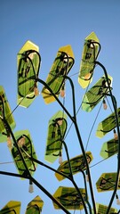 Modern eco-friendly street lamps designed as green leaves with solar panels. 