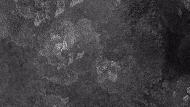Abstract dark grey stone texture with subtle light patches.