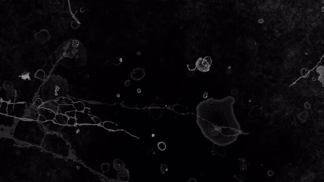 Abstract dark grunge texture with liquid ink spots and scratches overlay.