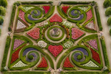 Fototapeta premium Geometric parterre garden with colorful flowers, aerial view, symmetrical pattern.