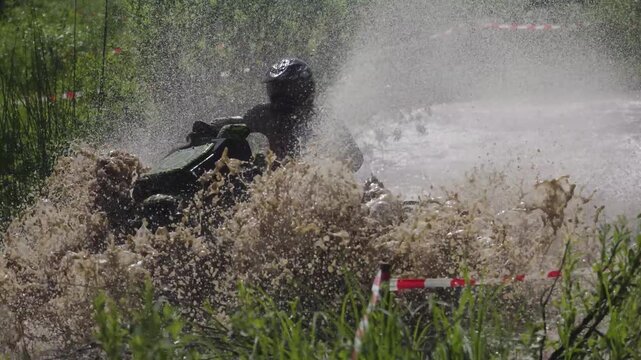Extreme ATV jump through water with dramatic splash action