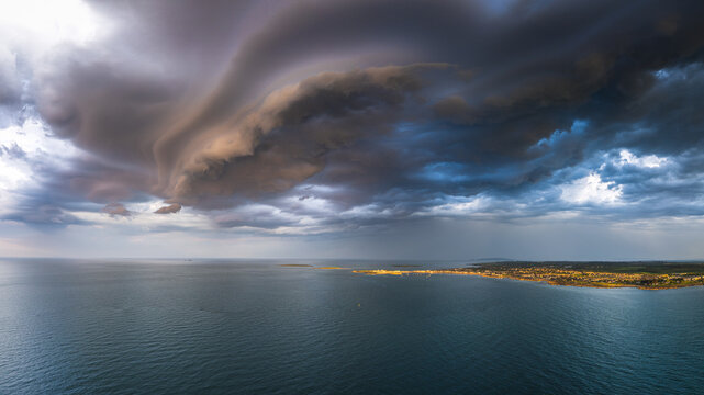 Skerries, County Dublin, Ireland - 23 June 2026: Aerial view of Skerries coastline under a dramatic, dark, swirling shelf cloud over the Irish Sea.