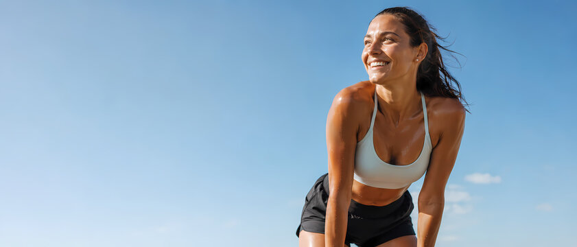 Athletic woman breathing happily after a long run
