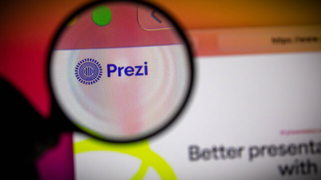 Closeup of the prezi logo on a computer screen viewed through a magnifying glass