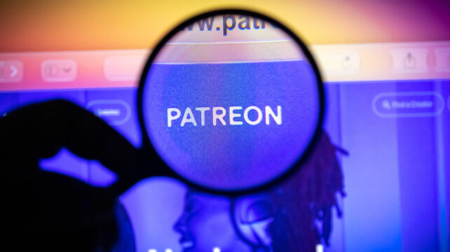 Magnifying glass focused on the patreon logo on a computer screen