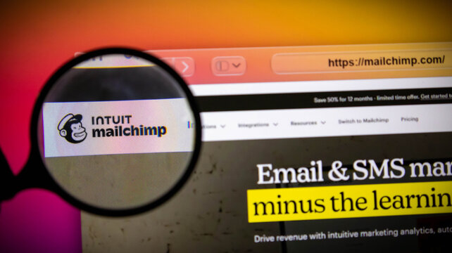 Closeup of a magnifying glass over the mailchimp logo on a computer screen