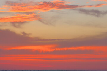 Fototapeta premium Cloudscape, Colored Clouds at Sunset near the Ocean on the Beach