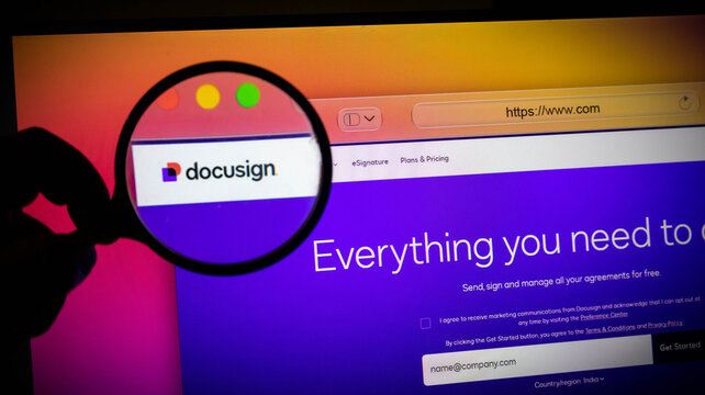 Closeup of a magnifying glass over a docusign website on a computer screen