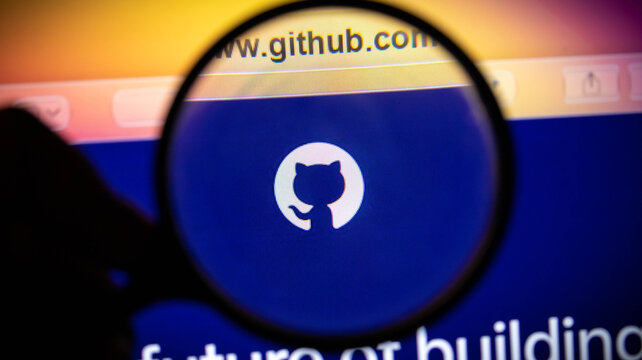 Magnifying glass over the github logo on a computer screen