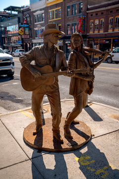 Nashville, Tennessee - June 6, 2026: Bronze sculpture of a country music guitarist and fiddler on Lower Broadway in downtown Nashville, Tennessee.
