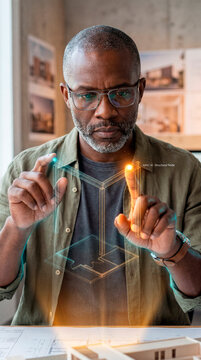 Focused Architect Selecting Holographic Node in Studio