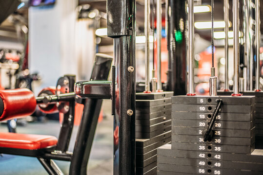 Gimnasio bien iluminado con una gran variedad de equipos para hacer ejercicio
