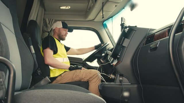Truck driver sitting in cabin preparing for driving