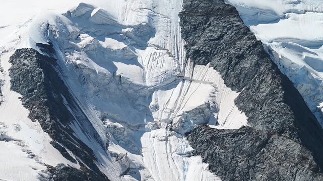 Aerial View of Alpine Glacier Ice Face, Seracs and Snow-Covered Mountain Summit, Bernina, Switzerland