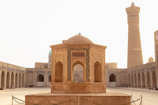 Kalyan Mosque courtyard with octagonal pavilion and Kalyan Minaret in Bukhara, Uzbekistan. Historic Islamic architecture ideal for travel publications and cultural heritage projects.
